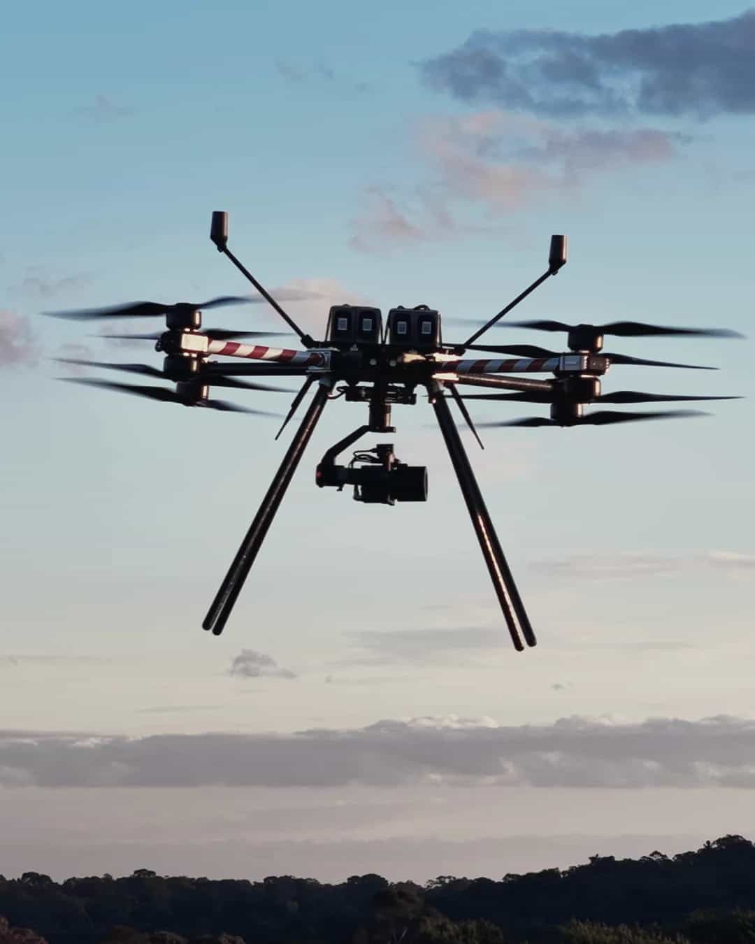 A Callisto 50 with its gimbal camera in flight against a blue sky and cloud